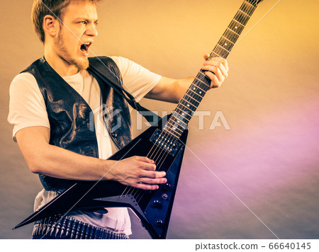 Young man playing electric guitar Young man playing electric guitar 66640145