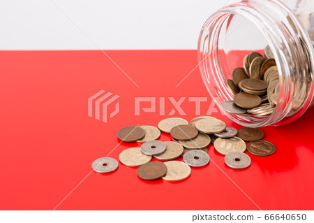 Image of spilling money red background 66640650