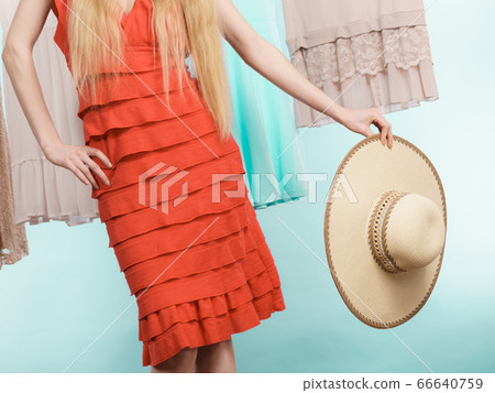 Woman in shop or wardrobe picking clothes Woman in shop or wardrobe picking clothes 66640759