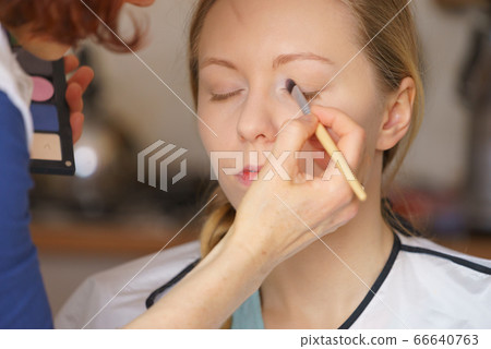 Woman getting make up done by artist Woman getting make up done by artist 66640763