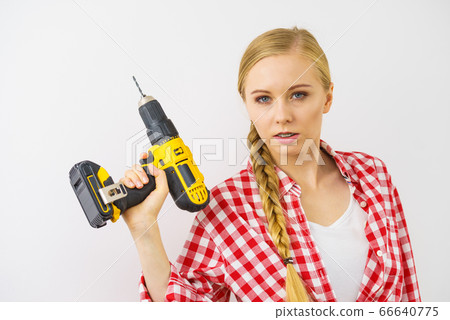 Woman aiming with drill Woman aiming with drill 66640775