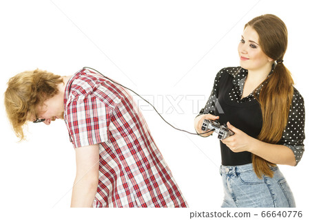 Woman controling man using gaming pad 66640776