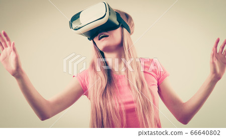 Girl wearing virtual reality goggles. Girl wearing virtual reality goggles. 66640802