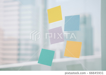 Colourful sticky paper note on the glass wall over 66645931