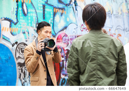 Street corner snap cameraman graffiti tagging Street corner snap cameraman graffiti tagging 66647649
