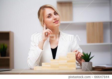 Business growth concept, beautiful young woman businesswoman builds company development plans 66647844