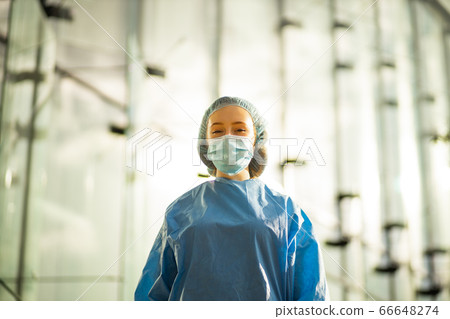 Confident medical doctor in surgical mask and surgical cap Confident medical doctor in surgical mask and surgical cap 66648274