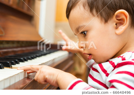 Litlle boy playing the piano Litlle boy playing the piano 66648496