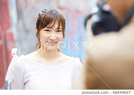 A young woman being photographed A young woman being photographed 66649687