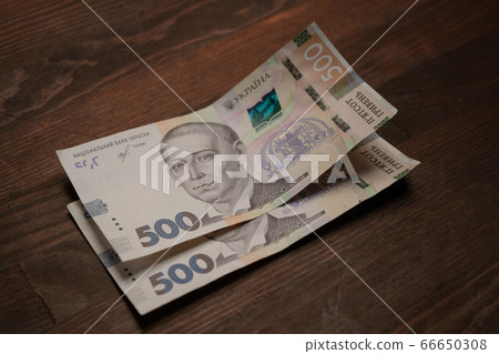 Two new five hundred hryvnia notes. New Ukrainian 500 hryvnias paper banknotes on table. Cash money concept. Deposit concept Two new five hundred hryvnia notes. New Ukrainian 500 hryvnias paper banknotes on table. Cash money concept. Deposit concept 66650308