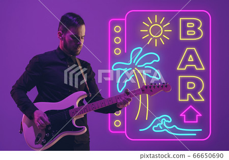 Young musician playing guitar in neon light on gradient background, inspired, artwork Young musician playing guitar in neon light on gradient background, inspired, artwork 66650690
