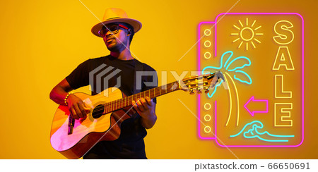 Young musician playing guitar in neon light on gradient background, inspired, artwork Young musician playing guitar in neon light on gradient background, inspired, artwork 66650691