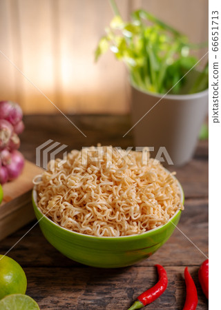 Noodle in a bowl with lime and chili and onion and Noodle in a bowl with lime and chili and onion and 66651713