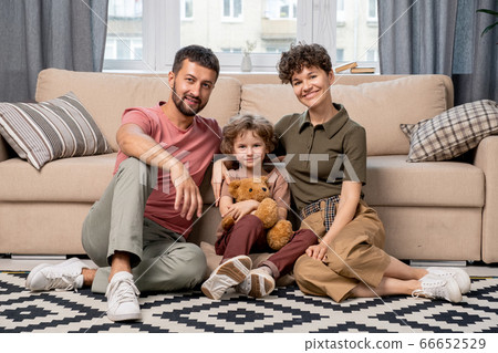 Cheerful family of young affectionate couple and their adorable little son 66652529