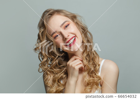 Pretty girl with blonde curly portrait 66654032