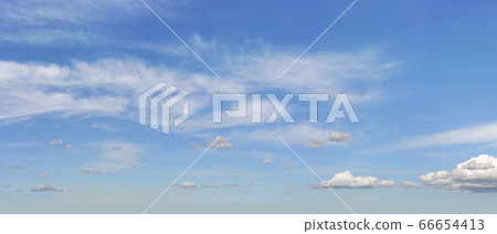 Bright sky background with few cirrus clouds above 66654413