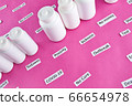 White plastic bottles with pills and coronavirus, pandemic headline clipping words 66654978