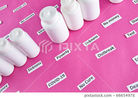 White plastic bottles with pills and coronavirus, pandemic headline clipping words White plastic bottles with pills and coronavirus, pandemic headline clipping words 66654978