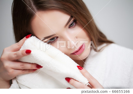 Cleansing facial skin, young woman holding white towel near facial skin after washing face Cleansing facial skin, young woman holding white towel near facial skin after washing face 66655166