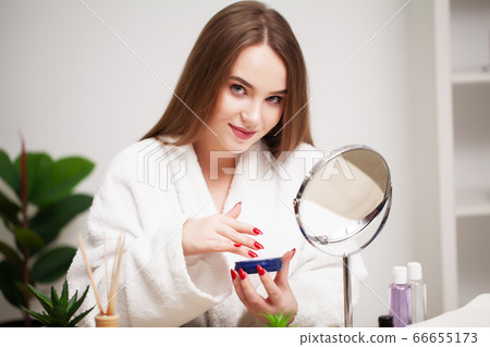 Skin care, young woman with beauty face use facial skin cream Skin care, young woman with beauty face use facial skin cream 66655173