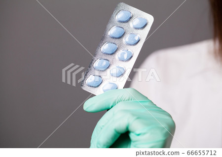 Doctor in gloves holds pills for men's sexual health Doctor in gloves holds pills for men's sexual health 66655712