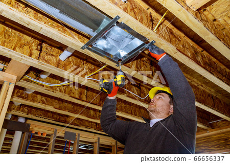 Male technician mounted air conditioner on ceiling 66656337