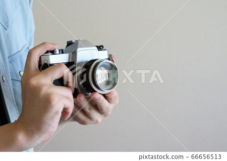 Person holding an old camera 66656513