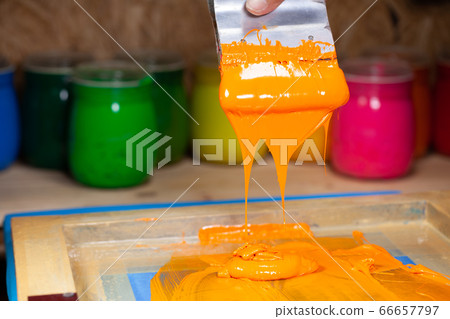 orange color dripping from hand screen printing orange color dripping from hand screen printing 66657797
