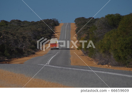 A school bus running on a vast road near Perth, Australia 66659609