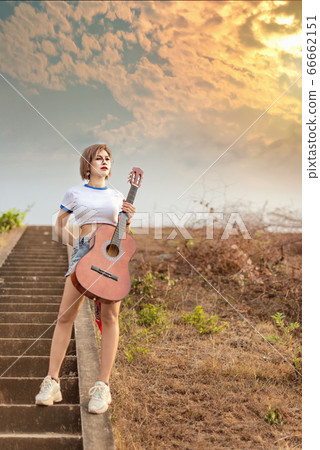 portrait of asian woman with guitar 66662151