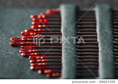 Sewing needles of different sizes in a set of red Sewing needles of different sizes in a set of red 66663306