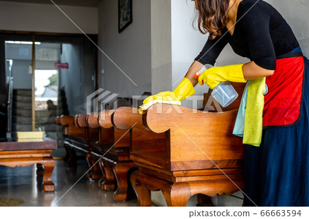 The housekeepers used cloth and cleaning solution to clean the table and chair The housekeepers used cloth and cleaning solution to clean the table and chair 66663594