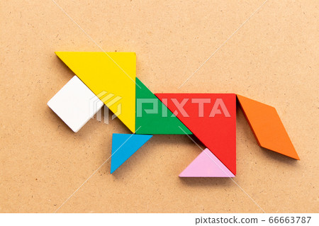 Color tangram puzzle in lion shape on wood background Color tangram puzzle in lion shape on wood background 66663787