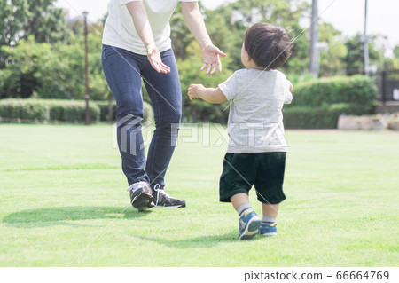 Mother and boy playing on the lawn 66664769