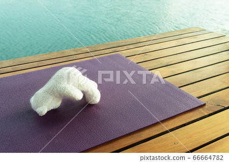 white bear doll yoga acting exercise on mat at cozy wood terrace 66664782