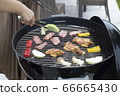 The gesture of grilling meat on a barbecue stove (without face) 66665430