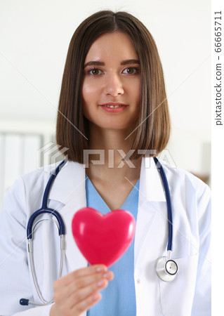 Female medicine doctor hold in hands red toy heart 66665711