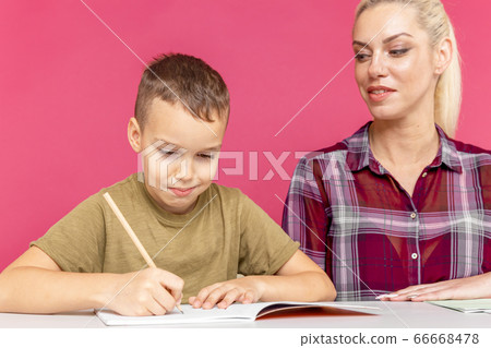 Distance education together. Mom with son doing homework together at home. Distance education together. Mom with son doing homework together at home. 66668478