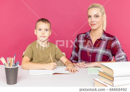 Mother with son at home doing homework together in quarantine time. Mother with son at home doing homework together in quarantine time. 66668492