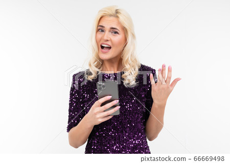portrait of pretty blonde woman in elegant circuit board displeasedly holding a phone in rucksack on 66669498