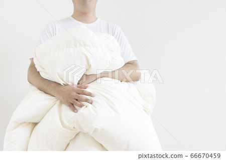 穿短袖襯衫,曬乾冬季棉被的男人 穿短袖襯衫,曬乾冬季棉被的男人 66670459
