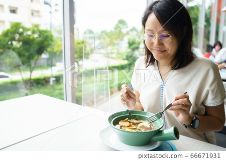New normal Middle-aged Asian woman Eating food 66671931