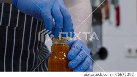 Man making fresh detox drink, closing bottle, close up Man making fresh detox drink, closing bottle, close up 66672396