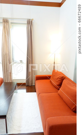 Living room (vertical screen) with an orange sofa on the side of the window where bright sunshine comes in (vertical screen) 1473 Living room (vertical screen) with an orange sofa on the side of the window where bright sunshine comes in (vertical screen) 1473 66672489