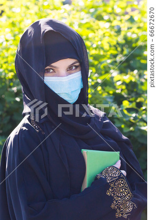 Oriental woman in a protective medical mask quaran Oriental woman in a protective medical mask quaran 66672670