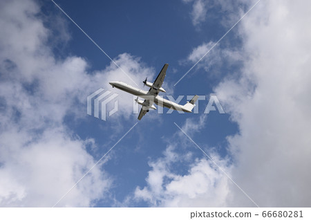 Domestic propeller airplane flying in the blue sky Domestic propeller airplane flying in the blue sky 66680281