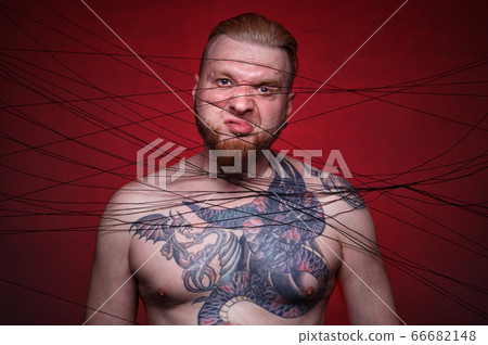 Image of tangled in black threads bearded angry man Image of tangled in black threads bearded angry man 66682148
