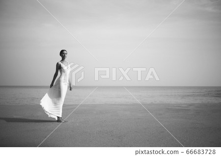 Young lady jumping on the beach Young lady jumping on the beach 66683728