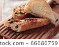 Fashionable bread on a wooden cutting board 66686759