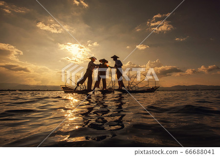 Intha Burmese fishermen on boat catching fish traditional at Inle Lake, Shan State, Myanmar Intha Burmese fishermen on boat catching fish traditional at Inle Lake, Shan State, Myanmar 66688041